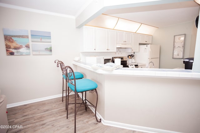 kitchen featuring light hardwood / wood-style floors, tile counters, white cabinets, kitchen peninsula, and stainless steel electric stove