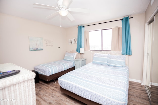 bedroom with light hardwood / wood-style floors and ceiling fan