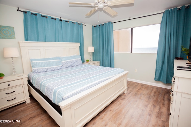 bedroom with hardwood / wood-style floors and ceiling fan