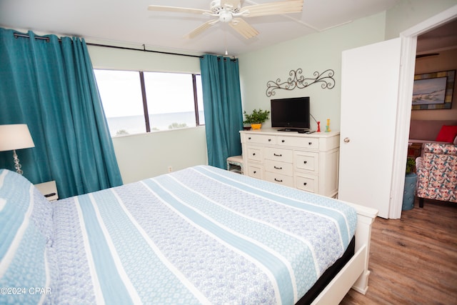 bedroom with ceiling fan and hardwood / wood-style flooring