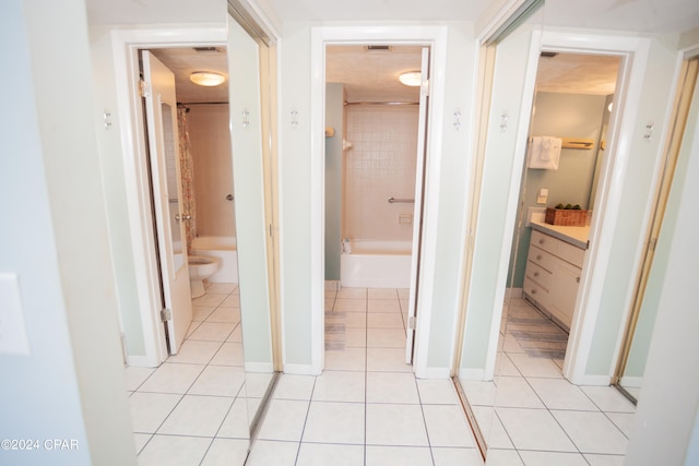 hall featuring light tile patterned floors