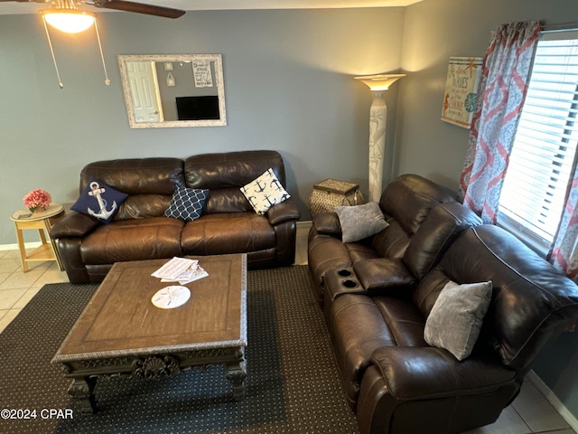 living room featuring ceiling fan, ornate columns, and tile patterned floors