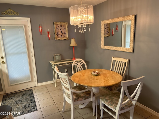 dining space featuring an inviting chandelier and light tile patterned floors