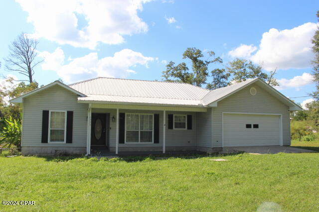 ranch-style home with a garage and a front yard