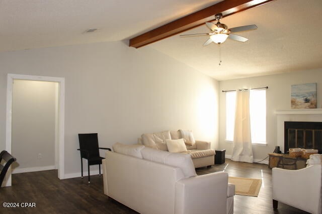 living room featuring lofted ceiling with beams, ceiling fan, and dark hardwood / wood-style flooring