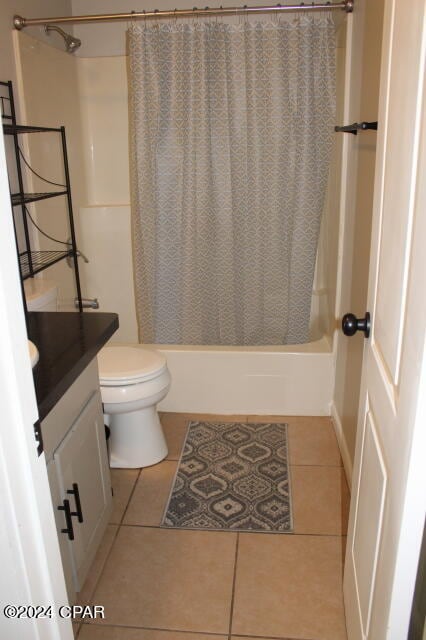 full bathroom with vanity, toilet, tile patterned flooring, and shower / tub combo with curtain