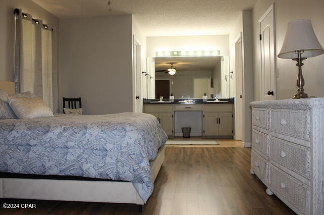 bedroom featuring hardwood / wood-style flooring and ensuite bath