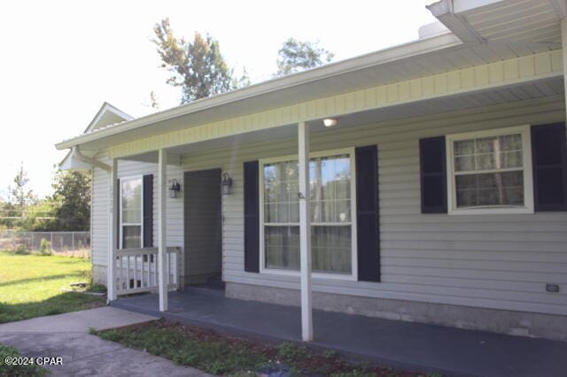 doorway to property featuring covered porch