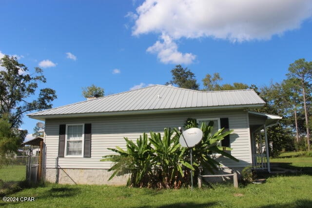 view of side of property with a yard