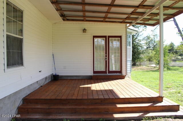 deck with a lawn and french doors