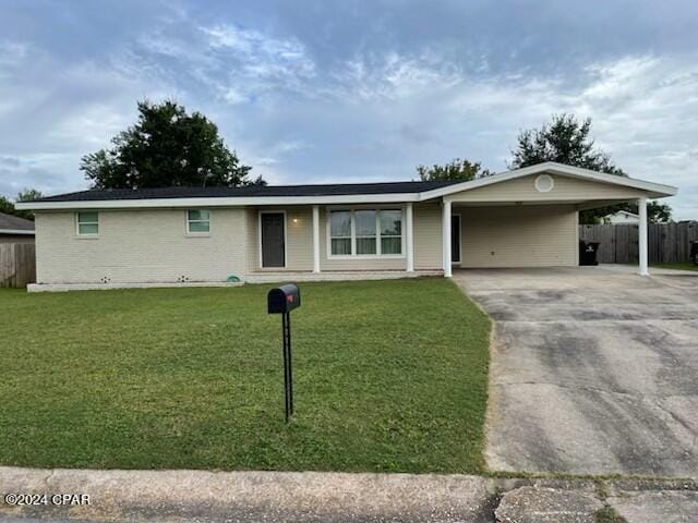 single story home featuring a carport and a front lawn