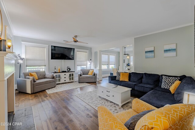 living room with plenty of natural light, a fireplace, ceiling fan, and hardwood / wood-style flooring