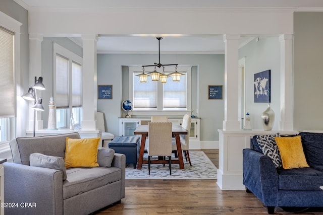 dining room featuring crown molding, dark hardwood / wood-style floors, and ornate columns