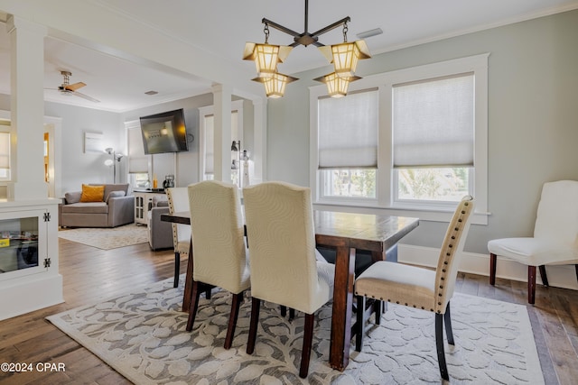 dining room with ornamental molding, ceiling fan, and dark wood-type flooring