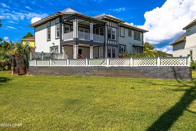 rear view of property featuring a yard