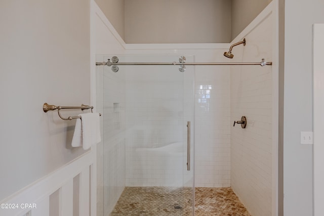 bathroom with a shower with door