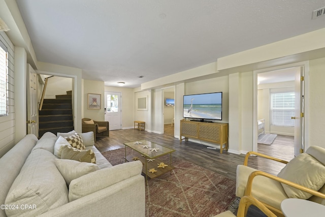 living room with dark hardwood / wood-style flooring and plenty of natural light