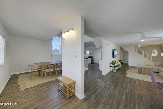 living room featuring ceiling fan and dark wood-type flooring