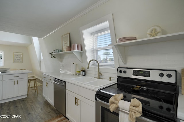 kitchen with white cabinets, sink, dark hardwood / wood-style floors, tasteful backsplash, and stainless steel appliances