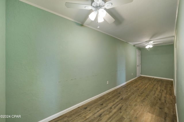 unfurnished room featuring ceiling fan, dark wood-type flooring, and ornamental molding