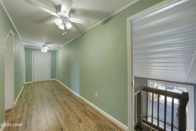 corridor with crown molding and light wood-type flooring