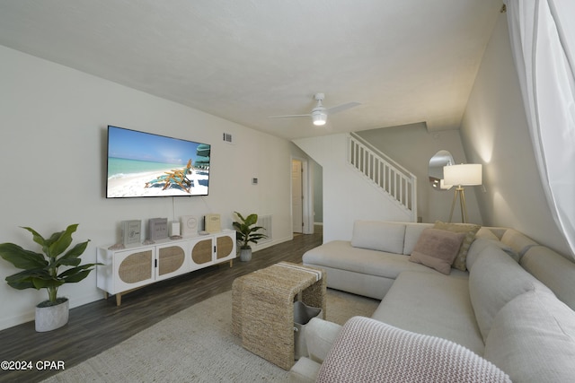 living room with ceiling fan and dark hardwood / wood-style flooring