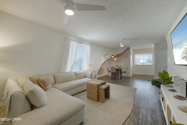 living room with dark hardwood / wood-style floors and ceiling fan