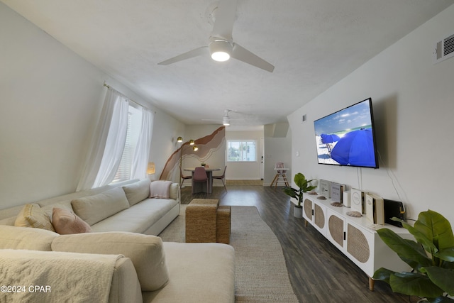 living room featuring dark hardwood / wood-style floors and ceiling fan