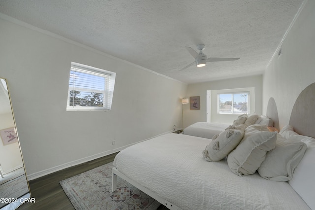 bedroom with a textured ceiling, dark hardwood / wood-style flooring, ceiling fan, and crown molding