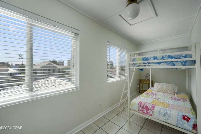 bedroom with ceiling fan and light tile patterned floors