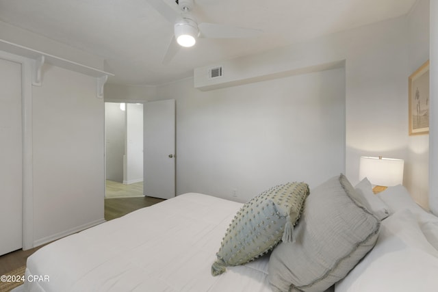 bedroom with ceiling fan and dark hardwood / wood-style flooring