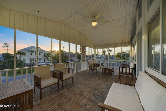 sunroom with ceiling fan and vaulted ceiling