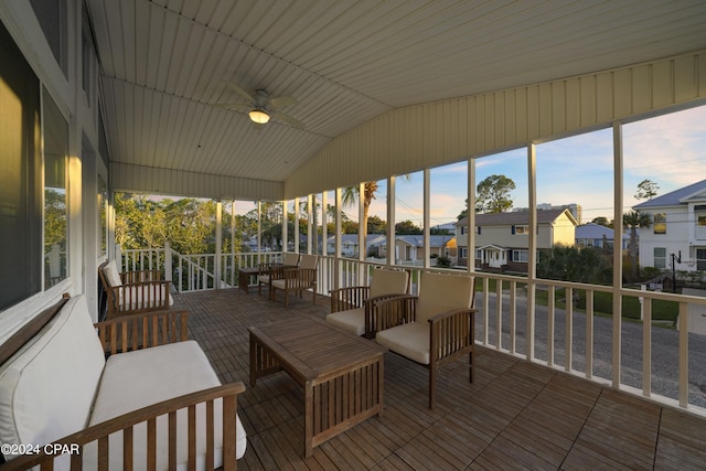 sunroom / solarium with ceiling fan, a healthy amount of sunlight, and lofted ceiling