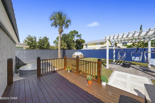 deck featuring a jacuzzi and a pergola