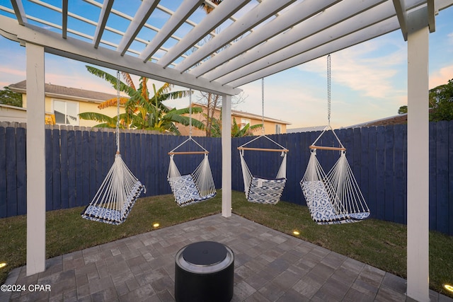 patio terrace at dusk with a pergola