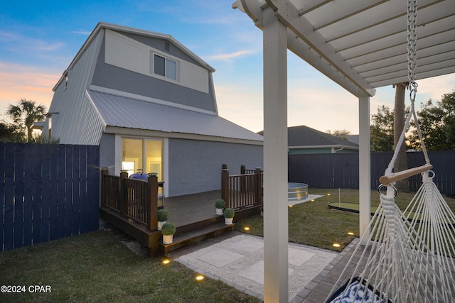 exterior space featuring a lawn and a deck