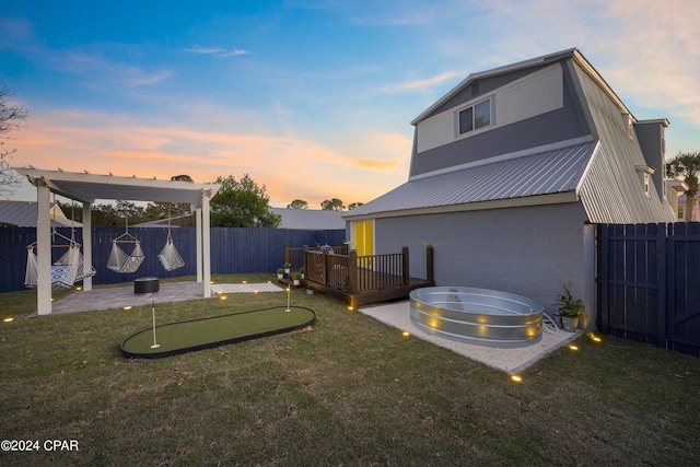 yard at dusk featuring a patio