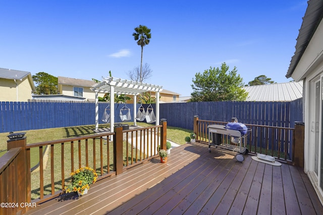 wooden deck with a pergola, area for grilling, and a lawn