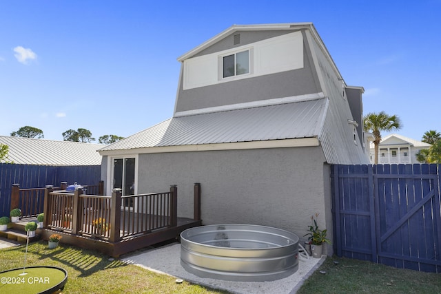 back of property with a wooden deck