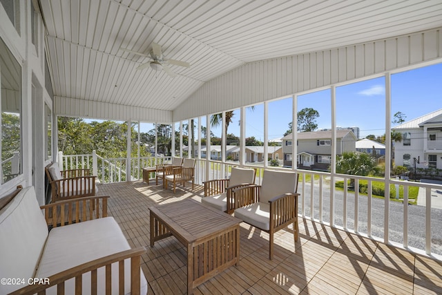 sunroom with ceiling fan and vaulted ceiling