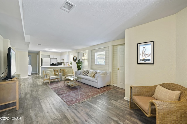 living room featuring hardwood / wood-style floors and a textured ceiling