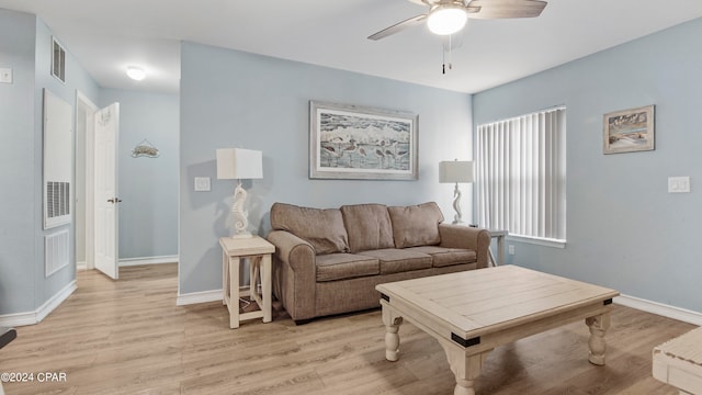 living room featuring light hardwood / wood-style flooring and ceiling fan