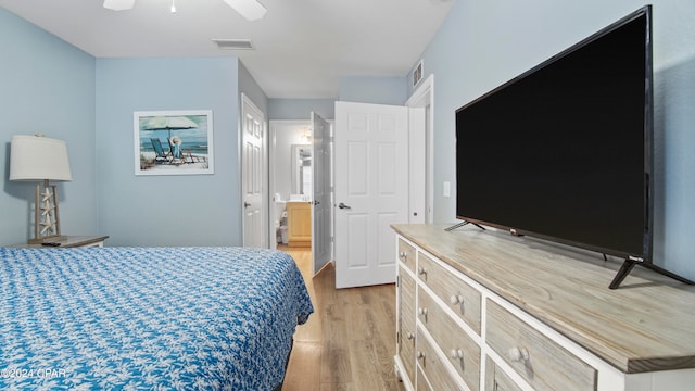 bedroom featuring ensuite bath, ceiling fan, and light hardwood / wood-style flooring