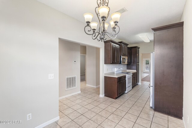 1300 Alabama Ave, Lynn Haven, FL 32444 - kitchen featuring stainless steel appliances, dark brown cabinets, a chandelier, light countertops, and light tile patterned flooring