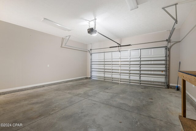 1300 Alabama Ave, Lynn Haven, FL 32444 - garage featuring baseboards and a garage door opener