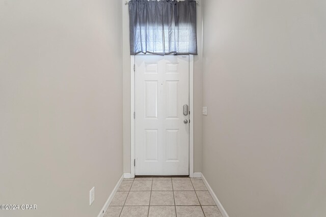 1300 Alabama Ave, Lynn Haven, FL 32444 - doorway with light tile patterned floors and baseboards