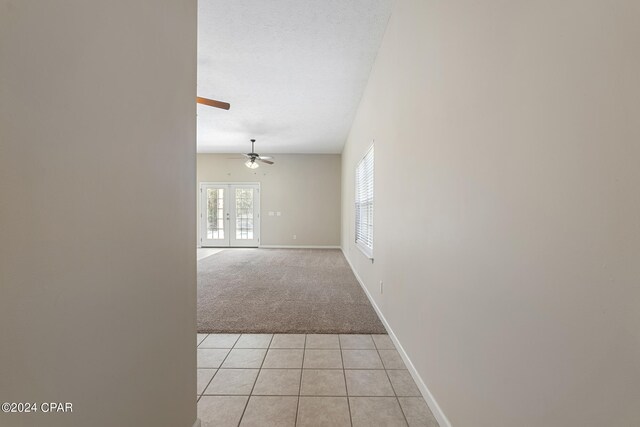 1300 Alabama Ave, Lynn Haven, FL 32444 - hallway with light colored carpet, light tile patterned flooring, baseboards, and french doors