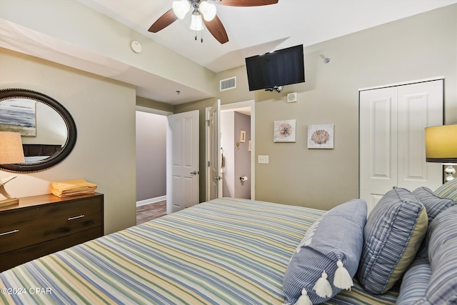 bedroom featuring ceiling fan, visible vents, and a closet