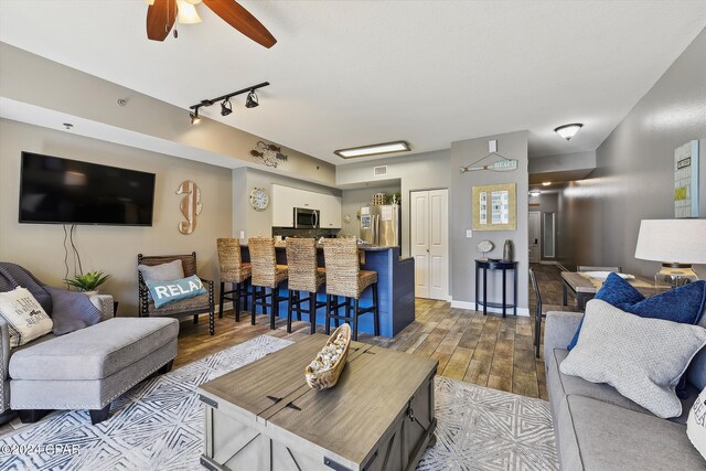 living room featuring ceiling fan and track lighting