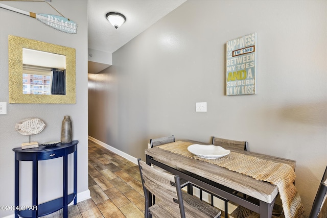 dining room with baseboards and wood tiled floor